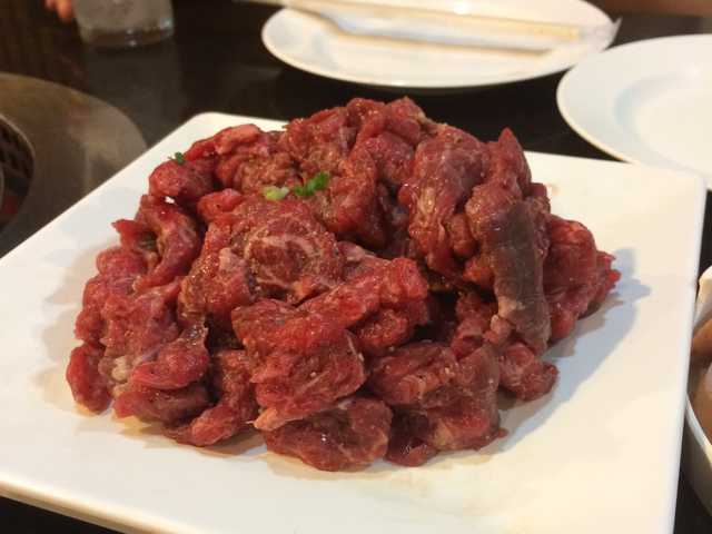 Photograph of a raw salted bavette steak.